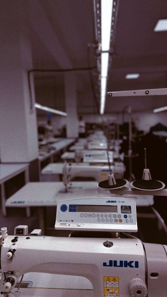 Crafting Captivating Headlines: Your awesome post title goes here A row of industrial sewing machines in a factory setting in Uzbekistan, highlighting modern textile production.